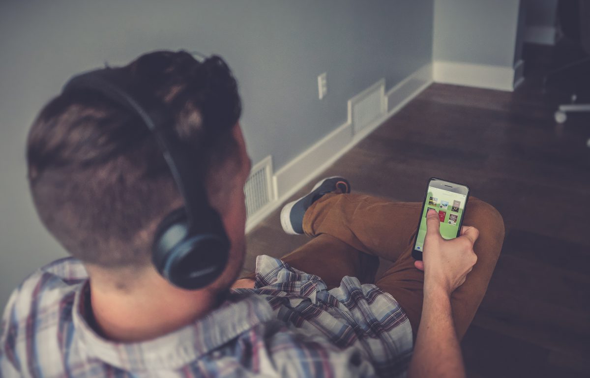 Man looking at iPhone | Photo by NeONBRAND on Unsplash